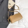 Minimalist light brown woven leather cylinder crossbody bag with slender shoulder strap - Khaki