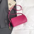 Fuchsia woven leather cylinder crossbody bag with golden metal buckle and shoulder strap - Rose Red