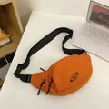 Sporty orange waist bag with black SLE logo and adjustable nylon strap on a white desk - Orange