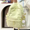Lichtgele nylon rugzak met grote capaciteit en een schattige witte pluche monster hanger - Geel met hanger