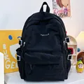 Minimalist black student backpack in high-quality nylon featuring a front zipper pocket - Black without Pendant