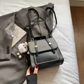Gray and black two-tone college style backpack with cute plush charm and gold buckles - Black With Pendant