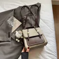 Vintage olive green and brown leather backpack with a cute white plush lamb keychain - Cream White With Pendant