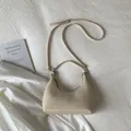 Detail of a beige woven hobo bag with adjustable strap on white fabric background - Off White
