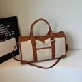 Vintage cream canvas travel bag with brown leather trim and dual handles - Brown