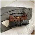 Braune und schwarze Patchwork-Beuteltasche mit klassischer Rautensteppung und Goldteilen - Braun