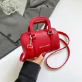Red mini Boston bag in lychee texture leather with dual handles and crossbody strap - Red