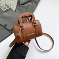 Chic brown lychee texture Boston bag with dual top handles and long crossbody strap - Brown