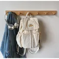 Creamy beige nylon drawstring backpack with yellow YOU JIBEAR embroidery detail - Off White