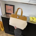 Bolso tote de lona con cuero jengibre, remaches metálicos y cierre giratorio - Sin colgante / Amarillo