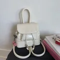Detail of cream vintage backpack with drawstrings and red cherry charm accessory - White with Pendant