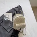 Beige quilted mini backpack with rhinestone details and silver chain strap on grey blazer - Off-white