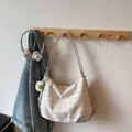 Chic beige checkered shoulder bag with cute plush pendant and oval leather logo patch - With Pendant / Off White