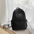 Mochila negra minimalista de nailon impermeable para mujer con bolsillo frontal con cremallera - Negro