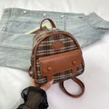 Mini brown plaid backpack with faux leather trim and Fashion logo held in hand - Brown