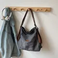 Large dark grey canvas tote bag with brown leather handles hanging on a wall hook - No Pendant / Black