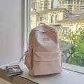 Mochila minimalista de nailon rosa claro para estudiantes con varios bolsillos con cremallera - Rosa