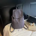 Chic mauve drawstring backpack for women with flap cover in a casual lifestyle setting - Blue Gray