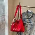 Red embroidered nylon shoulder bag with drawstring closure and tennis racket charm - With Charm / Red