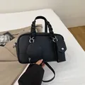 Three-piece black lychee leather Boston bag set with woven handles and a round coin pouch - Black