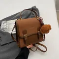 Retro brown dual-tone backpack with decorative straps and a cute plush dog pendant - With Charm / Brown