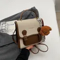 Chic Korean style beige and brown leather backpack featuring a plush poodle charm - With Charm / Off White