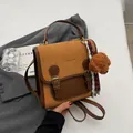 Brown leather crossbody backpack with suede panels and cute plush dog charm - With Charm / Orange