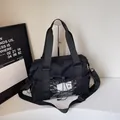 Large black lightweight travel tote with cross elastic cords and adjustable strap - Black