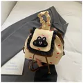 Beige mini backpack with red bow prints, ruffled lace trim, and plush cartoon patch - Brown
