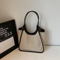 Minimalistische beige Canvas-Einkaufstasche mit schwarzem Besatz und Trapezform - Schwarz
