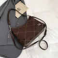 Dark brown quilted crossbody bag with matte finish and silver metal hardware details - Brown