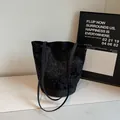 Black polka dot bucket tote bag with floral patterns and reinforced base - Black
