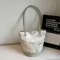 Off-white bucket bag with silver butterfly print and light green strap accents - Green