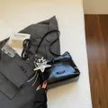 Glossy black patent leather shoulder bag with silver star and balloon dog charms - With Pendant / Black