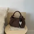 Dark brown suede hobo bag with pleated knot handle and silver heart pendant detail - Brown