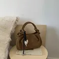 Brown pleated suede handbag with metal heart charm and woven strap accessory - Brown