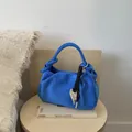 Klein blue pleated shoulder bag with suede texture and heart charm in a minimalist setting - Blue