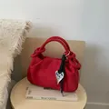 Red suede pleated shoulder bag with knot handle and silver heart pendant detail - Red