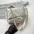 Chic silver quilted shoulder bag with wave stitching and gold chain strap detail - Silver