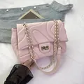 Light pink quilted crossbody bag with golden chain strap and swivel lock closure - Pink