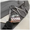 Silver cylindrical mini bag with red polka dots and a large bow on top - Silver