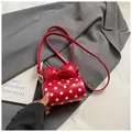Mini red polka dot handbag with a large 3D bow detail and silver metal hardware - Red