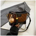 Deep brown quilted bucket bag with black base, chain strap and baseball charm - With Pendant / Black and Brown