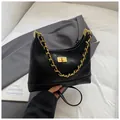 Chic black quilted hobo bag with gold chain strap and vintage square turn-lock closure - Black