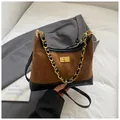 Brown suede hobo bag with diamond stitching, gold chain, and contrast black leather base - Brown