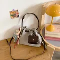 Light gray canvas drawstring bucket bag with brown woven handle and teddy bear charm - Small / Gray