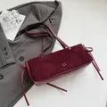 Deep red suede baguette shoulder bag featuring a decorative side bow and dual handles - No Pendant / Red