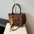 Leopard print bucket bag in brown faux fur with leather handles and wooden bead charm - Leopard Print With Pendant