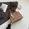 Brown textured woven square handbag with adjustable strap and fashion webbing detail - Brown