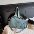 Detail of light blue nylon tote bag showing durable stitching and logo embroidery - Blue